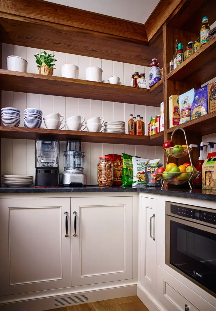 Custom walk in pantry with shelves and cabinets