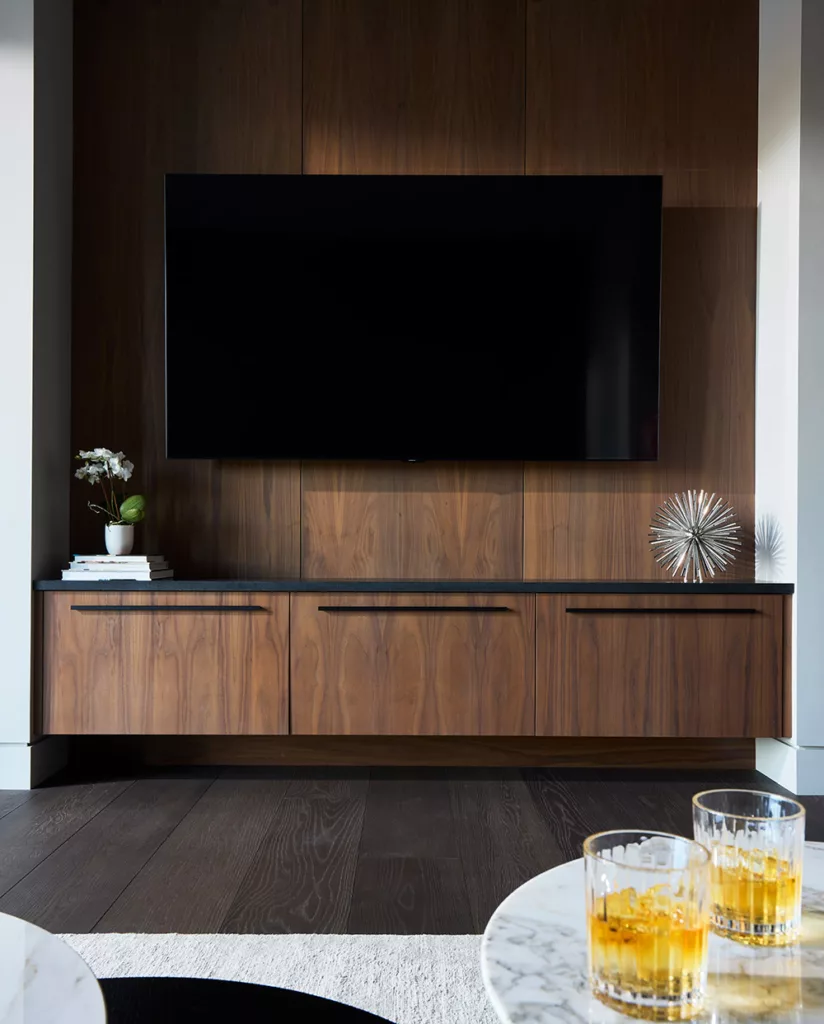 Living room custom storage cabinets with a wall mounted TV