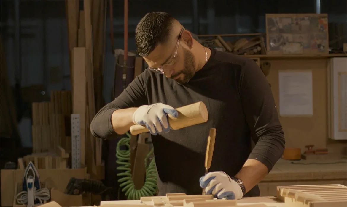 Craftsperson working to create custom cabinets
