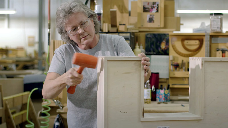 Craftsperson working to create custom cabinets